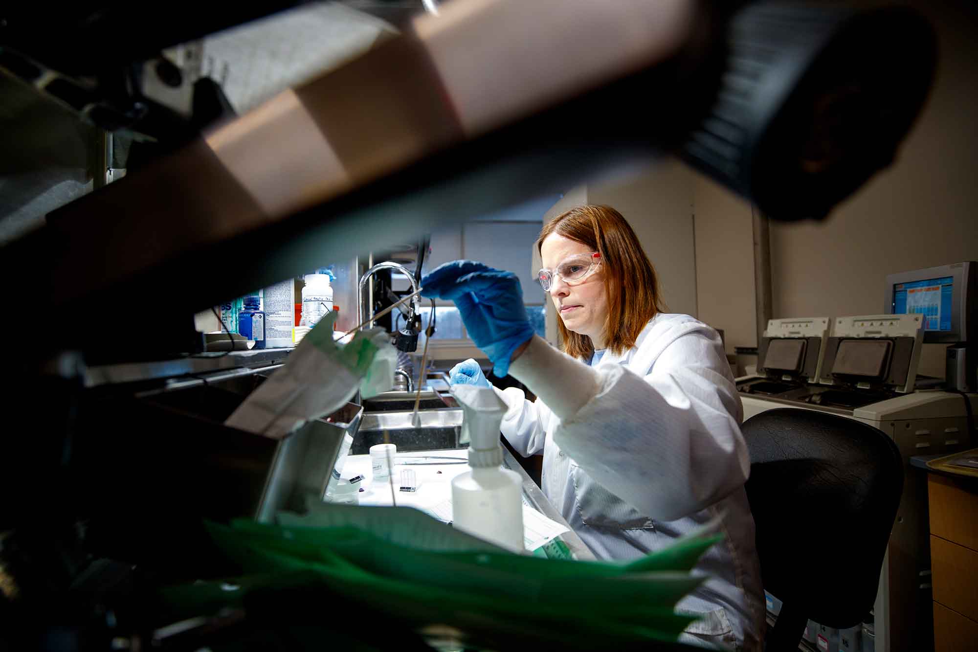 Female scientist at lab desk with equipment