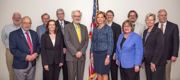 Dr. Christopher Yeaw (back row third from the right in light jacket) was recently appointed as a federal advisor on the Defense Programs Advisory Committee (DPAC).