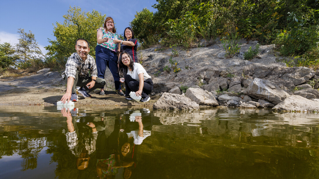 Researchers collect and examine water samples from the Elkhorn River near Waterloo, Nebraska, as part of the EPA research project.