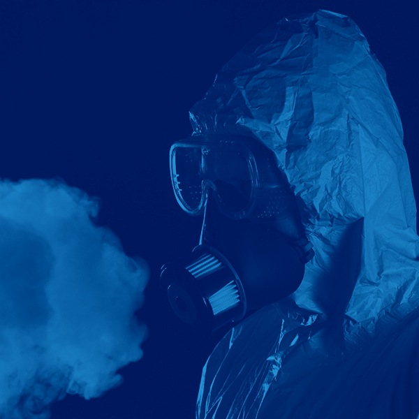 Portrait of a man in chemical suit with respirator and goggles. Concept of protection against viruses, biological attack or chemical pollution.