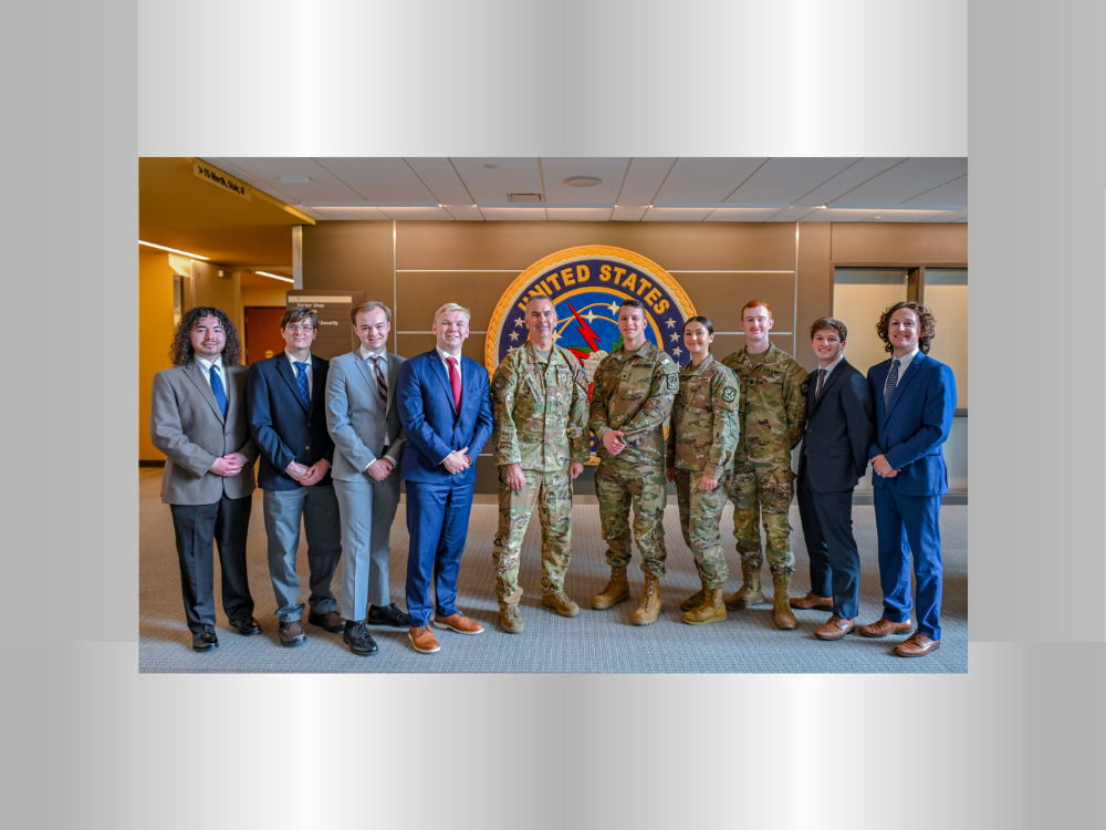 A diverse group of military personnel, consisting of both men and women, wearing military uniforms and business suits at USSTRATCOM HQ, Offuftt AIr Force Base, Omaha, Nebraska