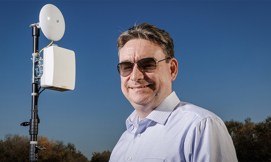 man in sunglasses in front of wireless box