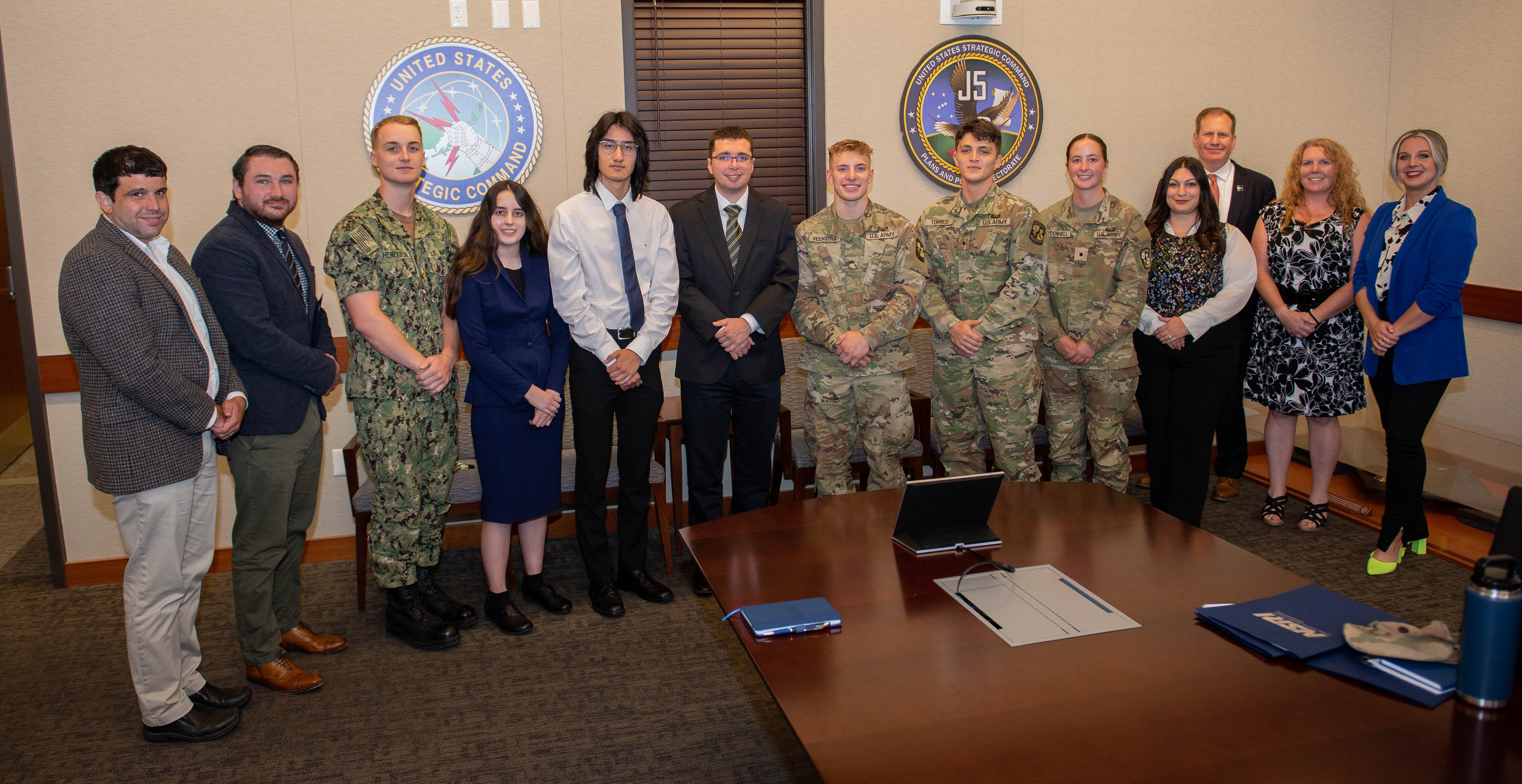 college students posing with usstratcom leader in uniform at stratcom headquarters