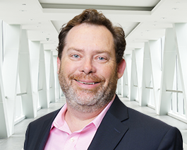 headshot of man in hallway