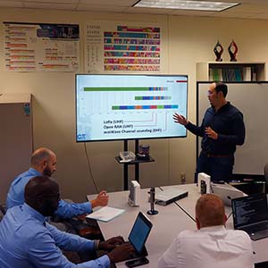 Researcher presents on a computer at the Cyber-Physical Networking Lab