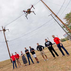 Team of eight researchers flying a drone