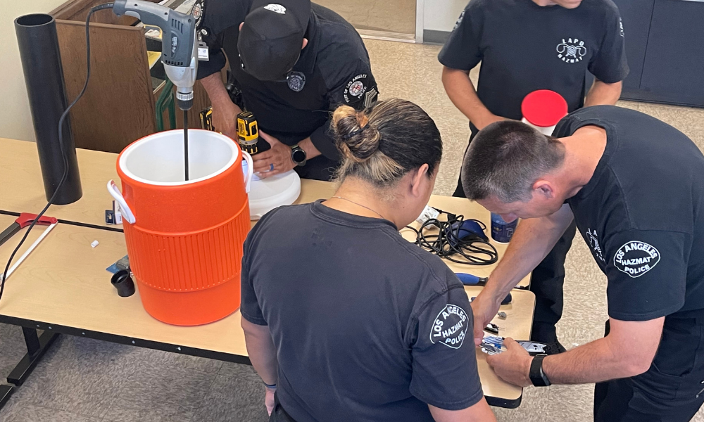 Officers collaborating in a classroom, engaged in a project.