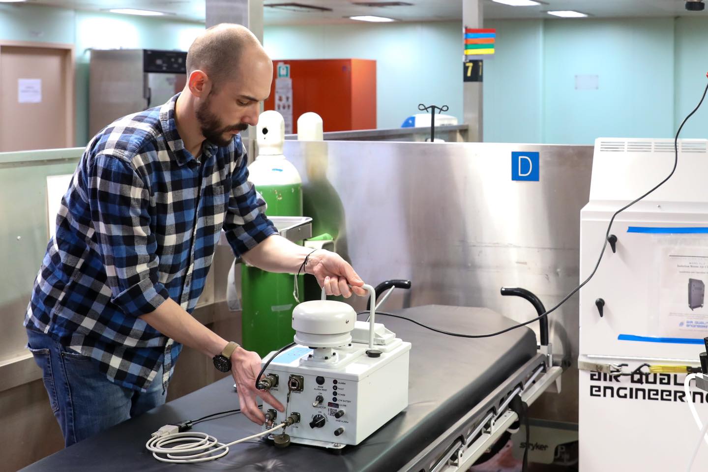 NSRI research scientist adjusts a particle sensor in preparation for a test.